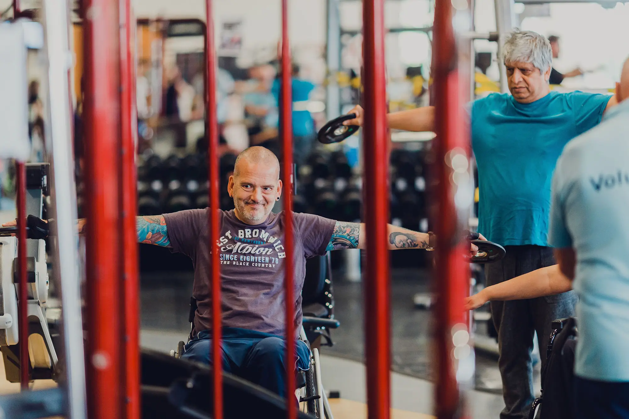 Man in wheelchair lifting weights in the gym